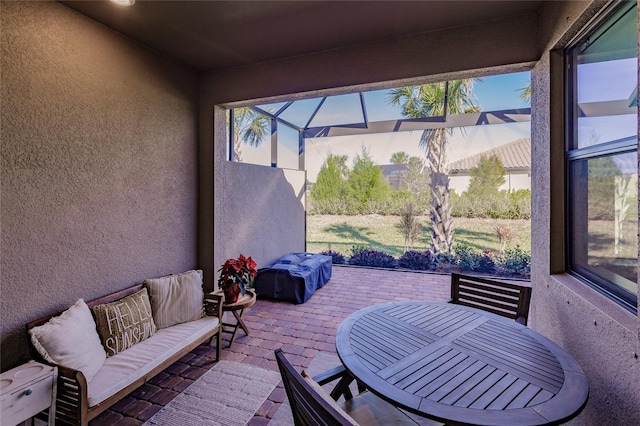 view of patio / terrace featuring a lanai