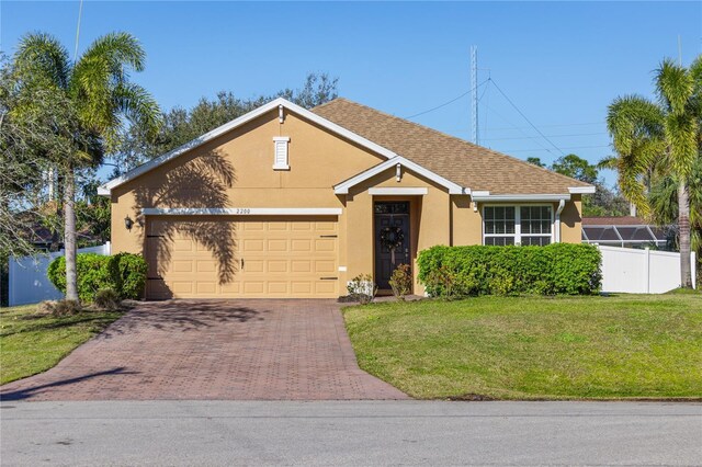 view of front of property with a garage and a front yard