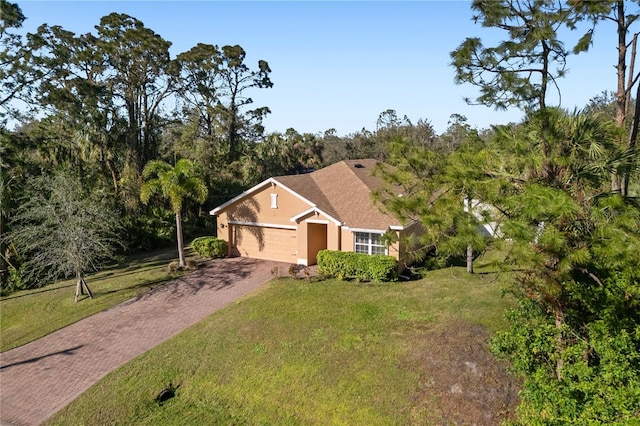 ranch-style home featuring a garage and a front yard