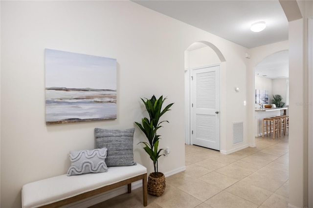 corridor with light tile patterned floors