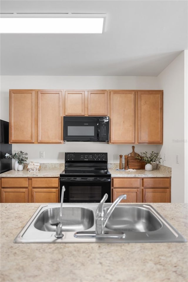 kitchen with sink and black appliances