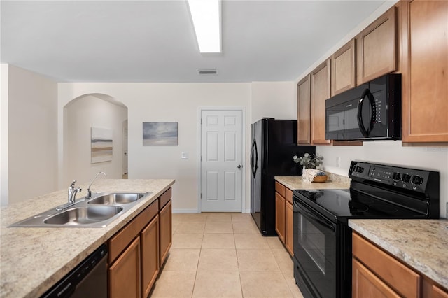 kitchen with light tile patterned floors, sink, and black appliances