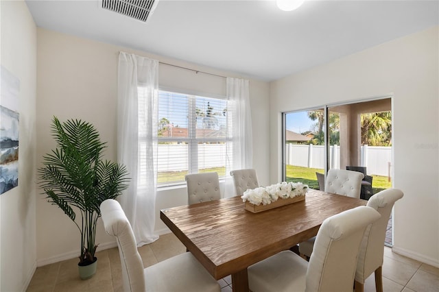 tiled dining area featuring a wealth of natural light