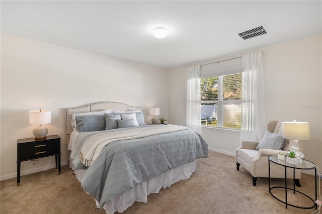 bedroom featuring light colored carpet