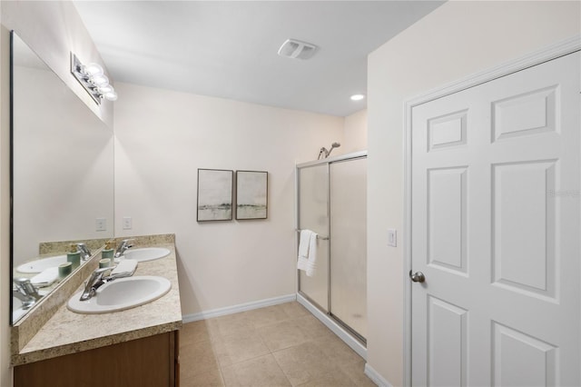 bathroom with tile patterned flooring, vanity, and a shower with shower door