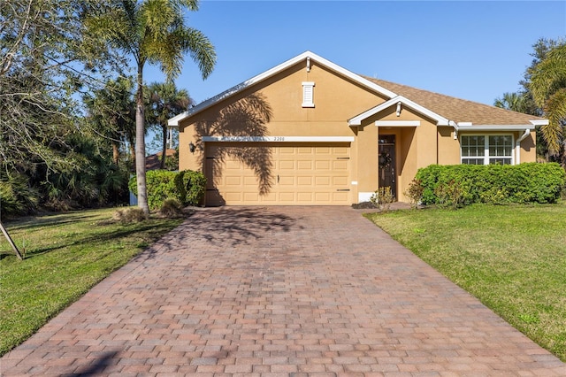 view of front of home with a garage and a front lawn