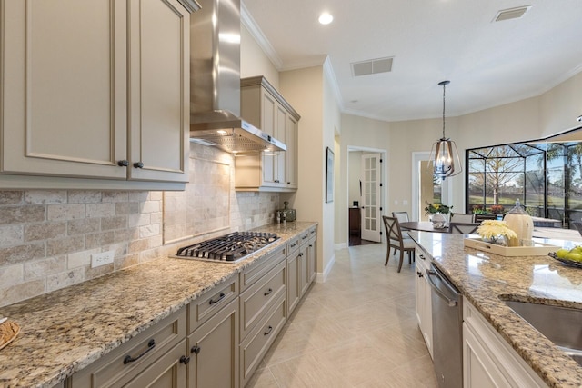 kitchen featuring light stone counters, wall chimney range hood, ornamental molding, and stainless steel appliances