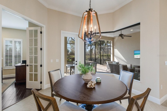 dining room with ornamental molding, hardwood / wood-style floors, a notable chandelier, and french doors