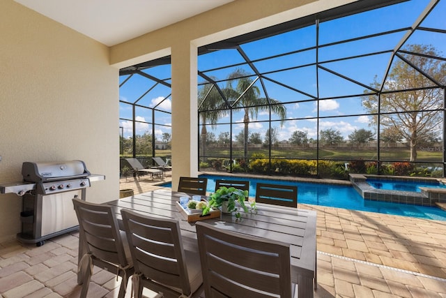 view of swimming pool featuring an in ground hot tub, a grill, a lanai, and a patio area