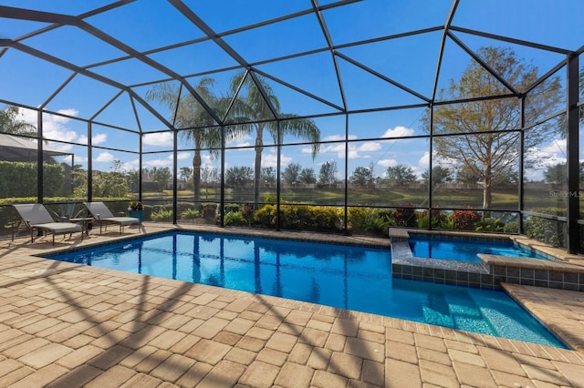 view of swimming pool featuring a lanai and a patio