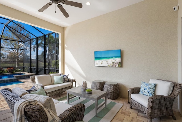 view of patio / terrace featuring an in ground hot tub, a lanai, an outdoor hangout area, and ceiling fan