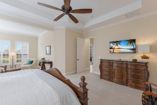 bedroom featuring ceiling fan, light colored carpet, ornamental molding, and a raised ceiling