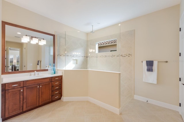 bathroom featuring vanity, tile patterned floors, and tiled shower