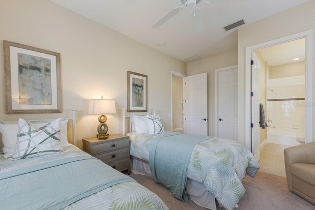 carpeted bedroom with ceiling fan and connected bathroom