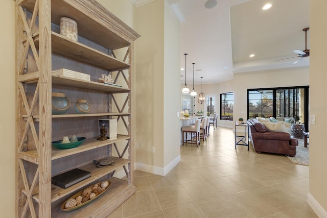 interior space featuring crown molding and light tile patterned flooring