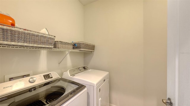 clothes washing area featuring washing machine and clothes dryer