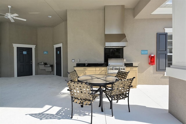 view of patio with sink, grilling area, ceiling fan, and exterior kitchen