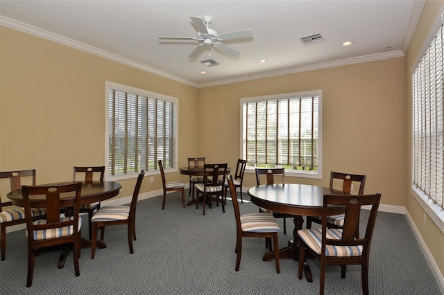 dining space featuring ceiling fan, ornamental molding, and carpet