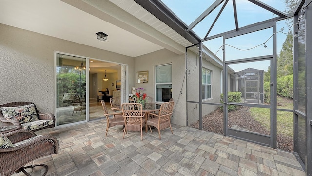 sunroom / solarium featuring beam ceiling