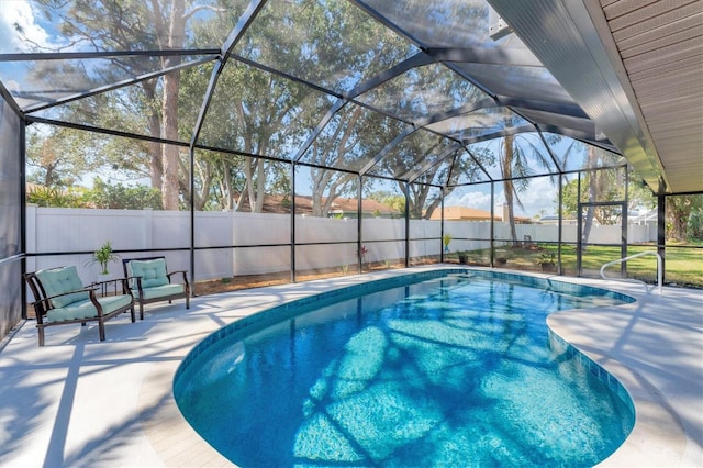 view of pool featuring a lanai, a fenced in pool, a fenced backyard, and a patio area