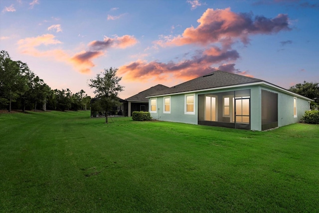 back house at dusk with a yard