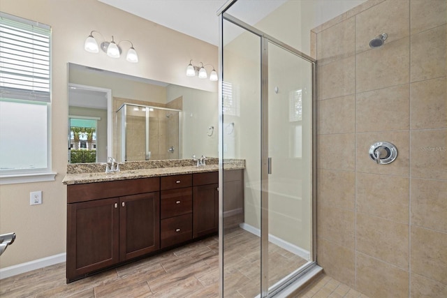 bathroom featuring vanity and an enclosed shower