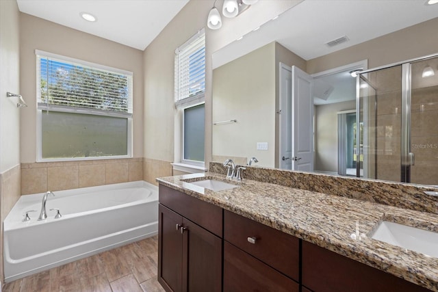 bathroom with vanity, shower with separate bathtub, and wood-type flooring