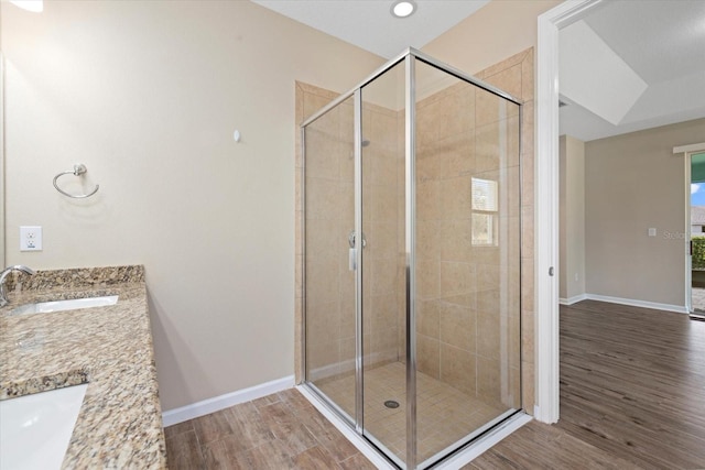 bathroom with vanity, an enclosed shower, and hardwood / wood-style flooring