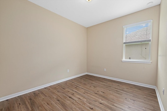 unfurnished room featuring hardwood / wood-style flooring