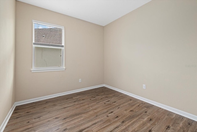 spare room featuring dark hardwood / wood-style floors