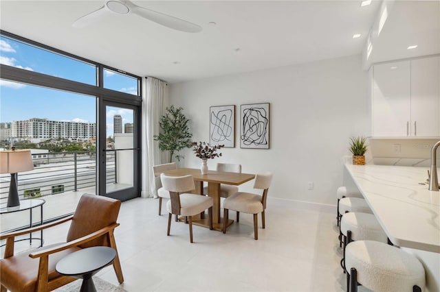 dining area featuring ceiling fan and floor to ceiling windows