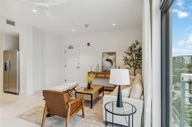 living room with ceiling fan and a healthy amount of sunlight