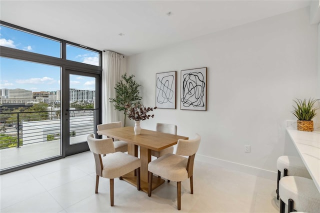 dining area with light tile patterned floors and expansive windows