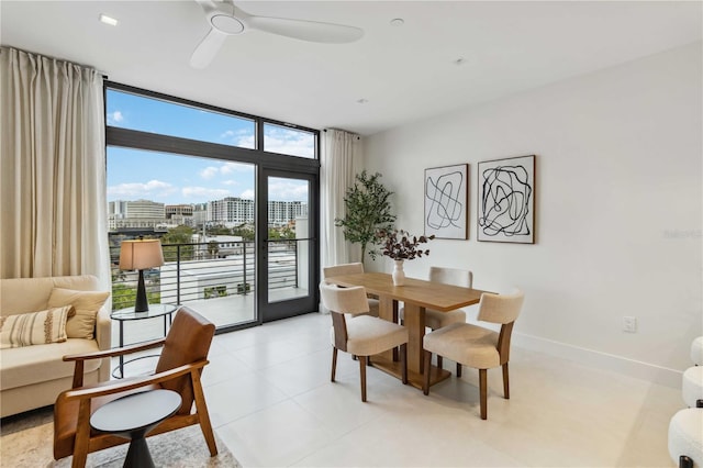 dining space with ceiling fan, floor to ceiling windows, and a wealth of natural light