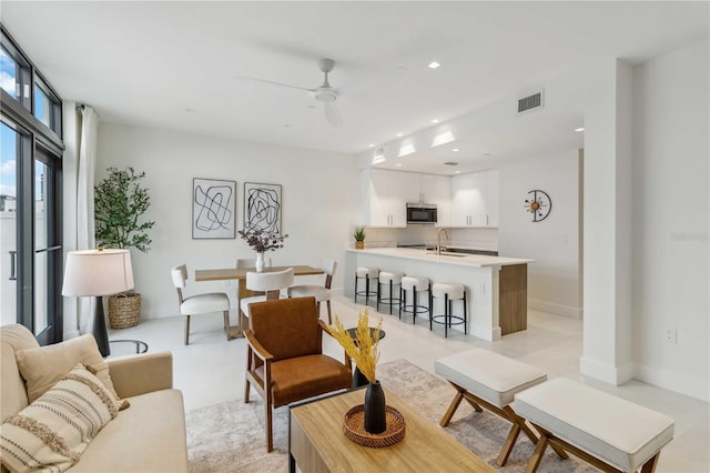 living room with sink and ceiling fan