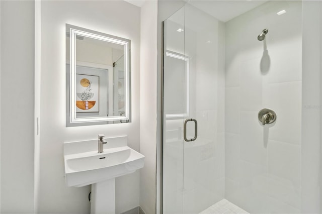 bathroom featuring a shower with shower door