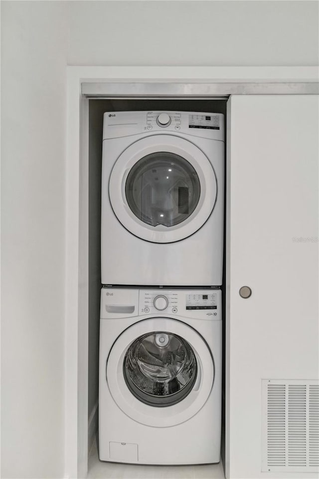 laundry area with stacked washer / dryer