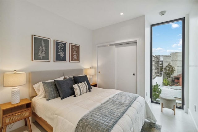 bedroom featuring expansive windows, access to exterior, and a closet