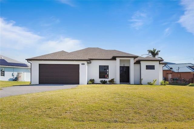 view of front of house with a garage and a front yard