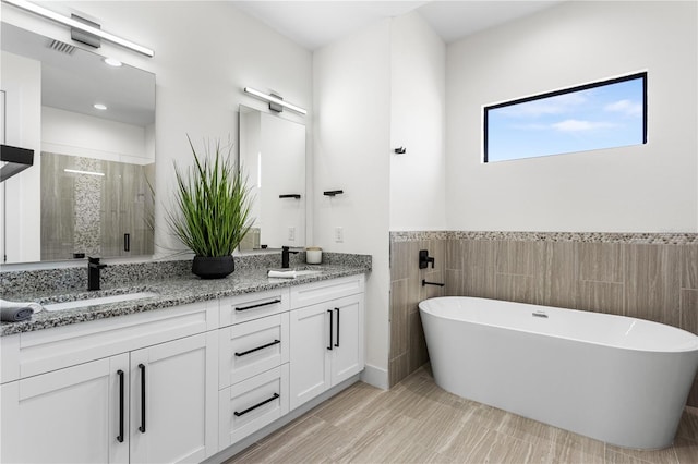 bathroom featuring vanity and plus walk in shower