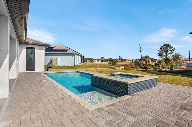 view of pool featuring a yard, a patio, and an in ground hot tub