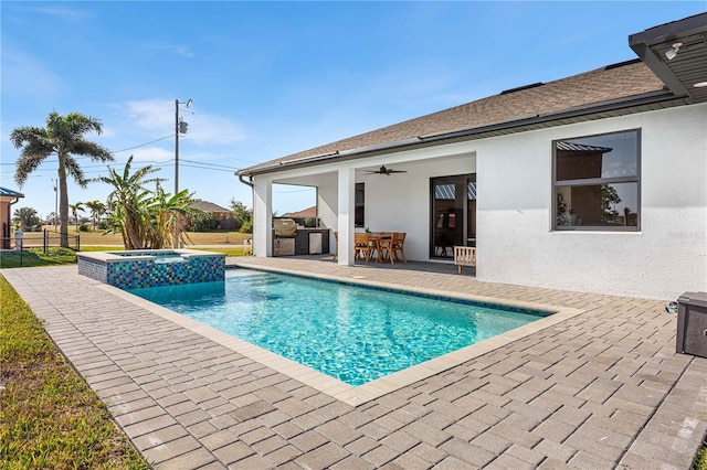 view of pool with an in ground hot tub, area for grilling, ceiling fan, and a patio area