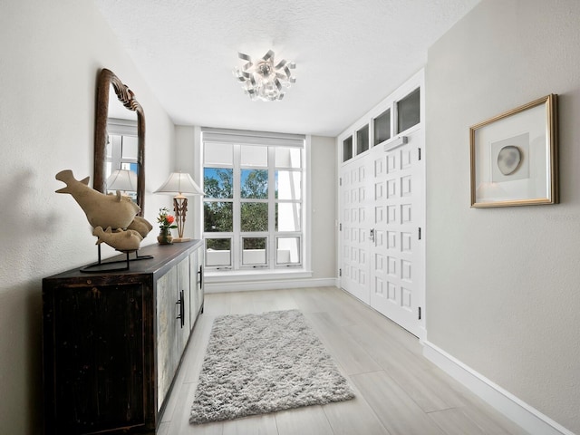 interior space featuring a textured ceiling and light hardwood / wood-style floors