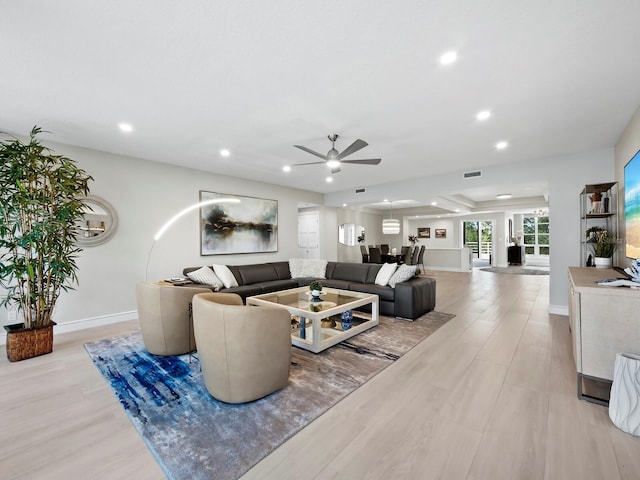 living room with ceiling fan and light hardwood / wood-style floors