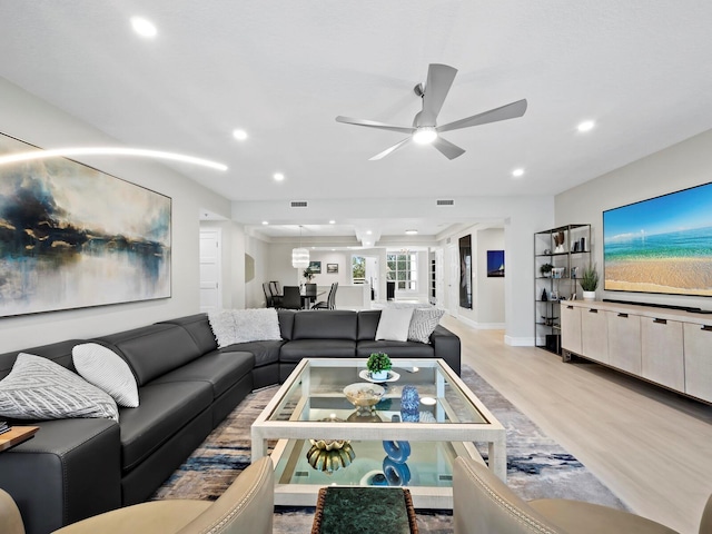 living room featuring ceiling fan and light wood-type flooring