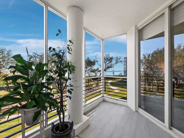 sunroom / solarium with a water view