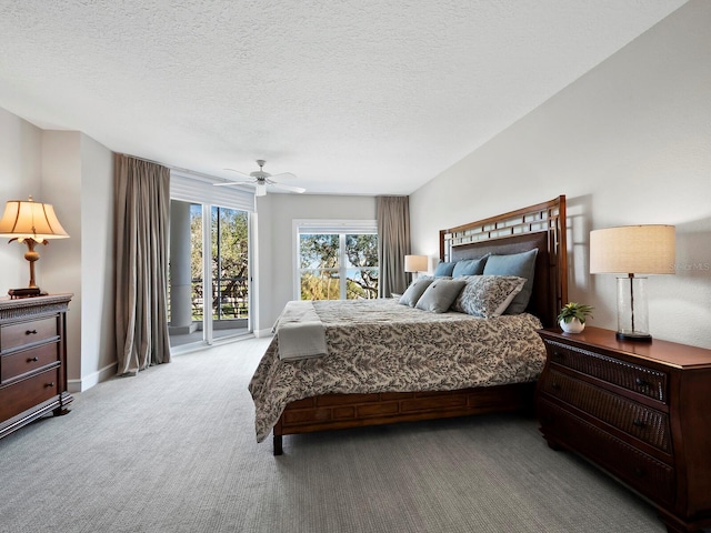 bedroom featuring light carpet, access to exterior, a textured ceiling, and ceiling fan