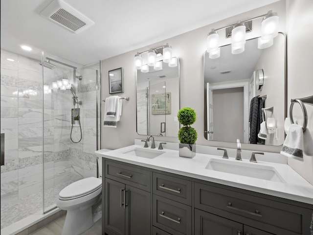 bathroom featuring vanity, an enclosed shower, and toilet