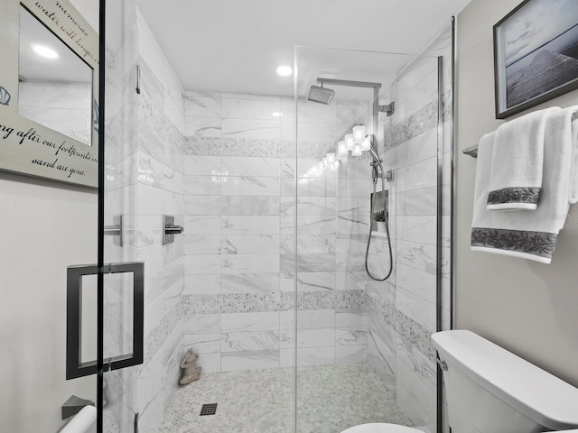 bathroom featuring walk in shower and toilet