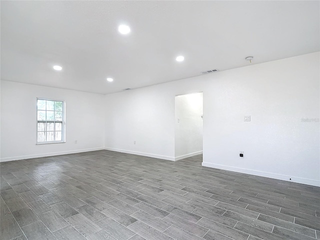 unfurnished room featuring dark hardwood / wood-style flooring